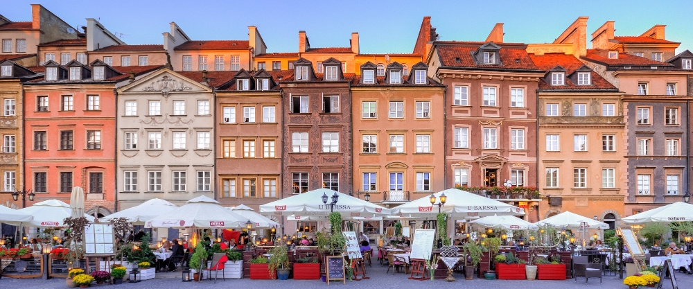 Historic houses with ornate façades and warm colours surrounding the central square of Warsaw's historic centre.